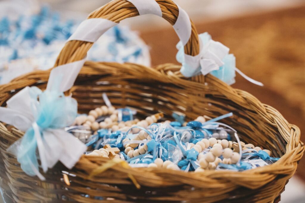 Basket with Blue and White Baptism Favors Displayed. Basket filled with elegant baptism favors, featuring blue and white details